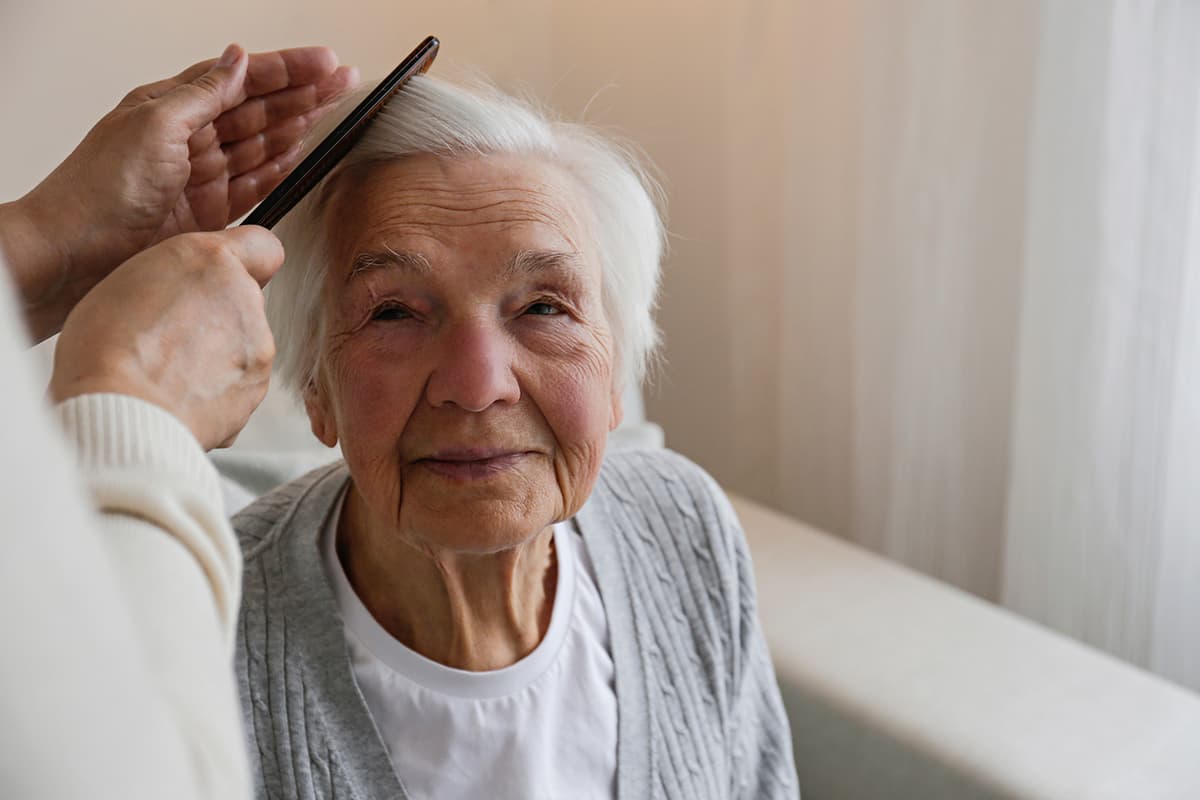 Caregiver providing personal care to a resident